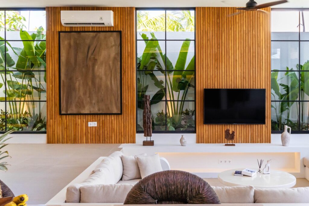 Living room with smart TV and local artwork, Casa di Cemagi
