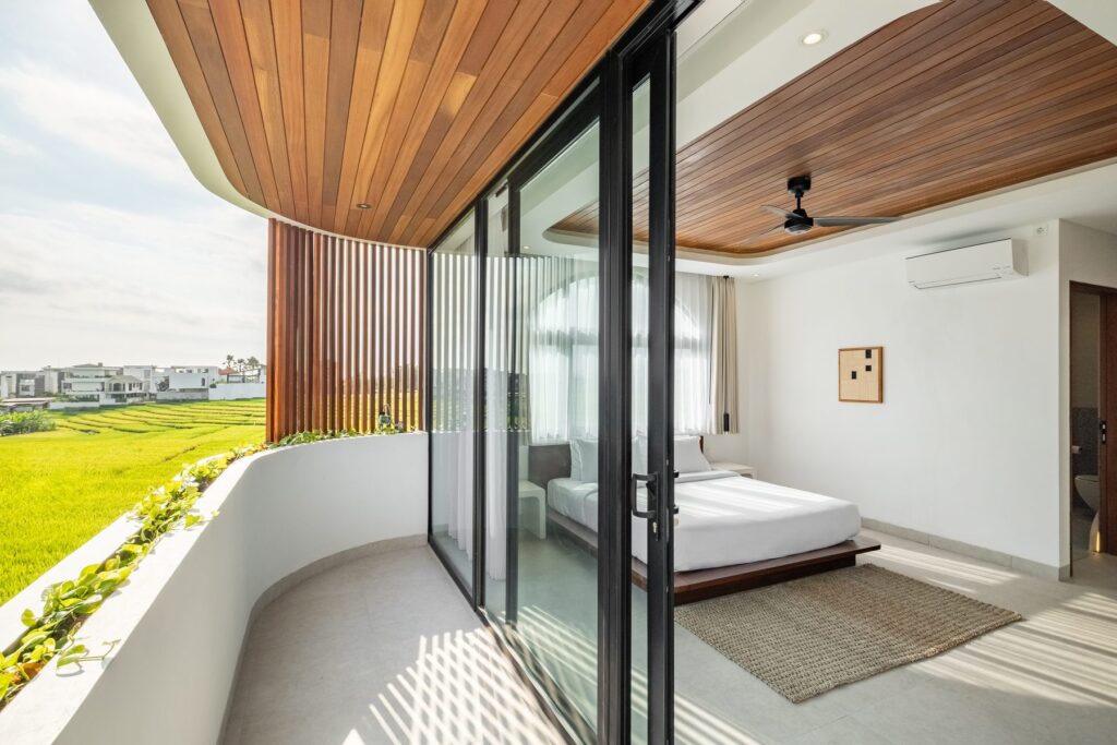 Bedroom opening to rice field views at Villa Quattro