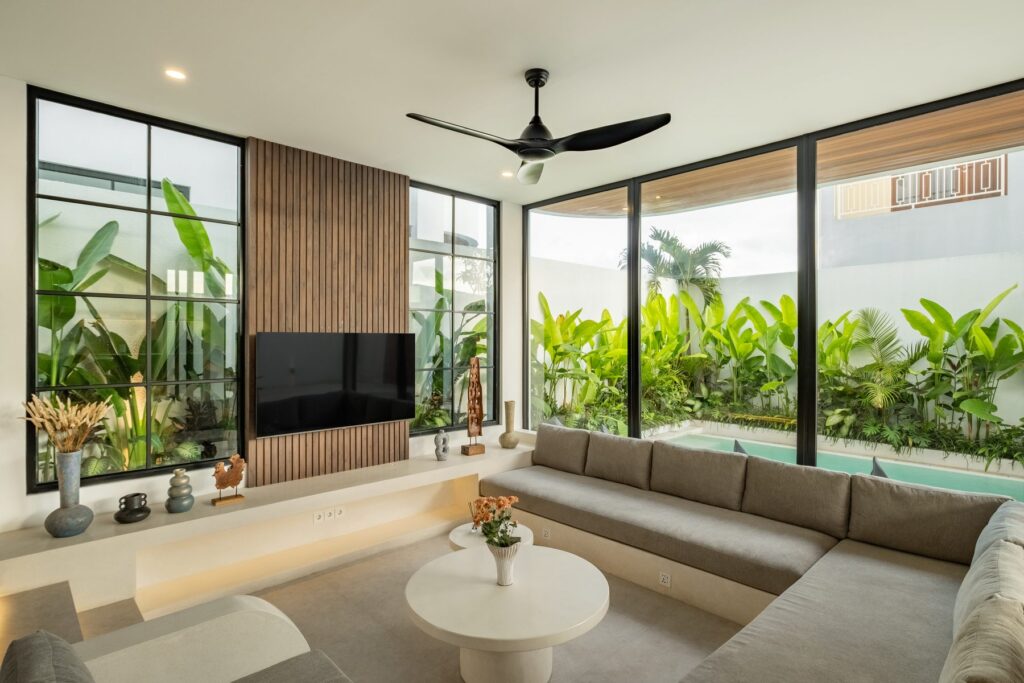 Living room with smart TV and pool view at Villa Quattro