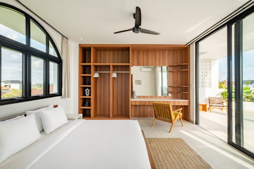 Master bedroom with built-in wardrobe and terrace view at Villa Quattro
